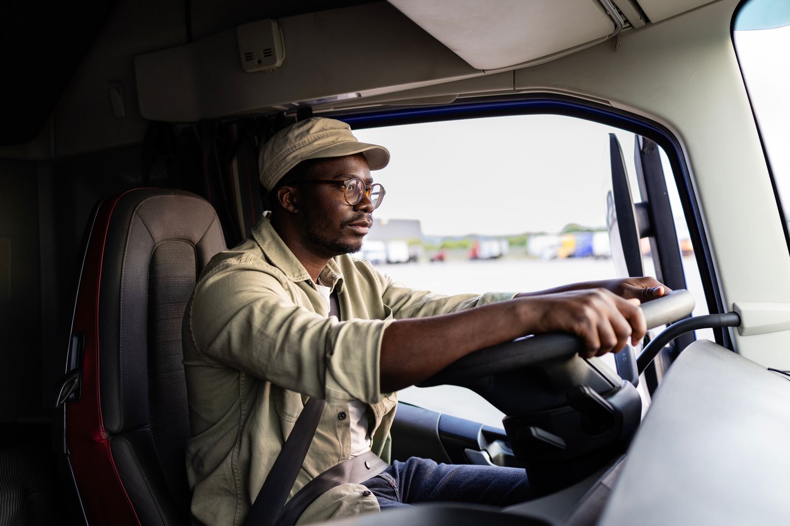 A truck driver behind the wheel, focused on the road ahead